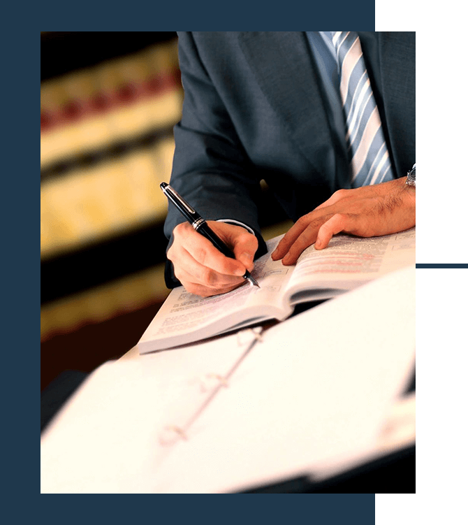 Man Writing on Book or Contract in the Office